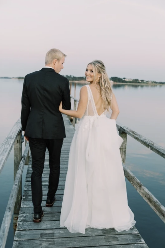married couple walking down a boat dock over the water at Wequassett Resort & Golf Club