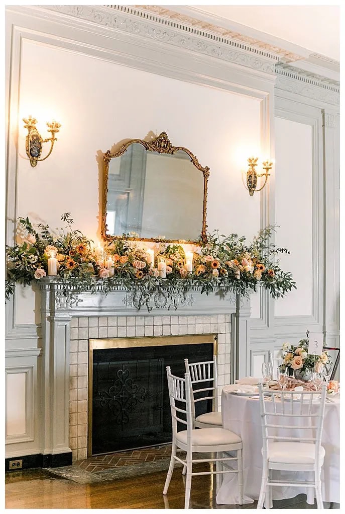 indoor reception space fireplace with florals on to at Eolia