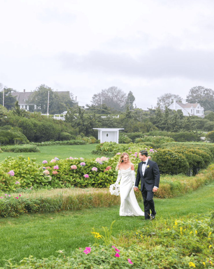 married couple walking in garden of the ocean house