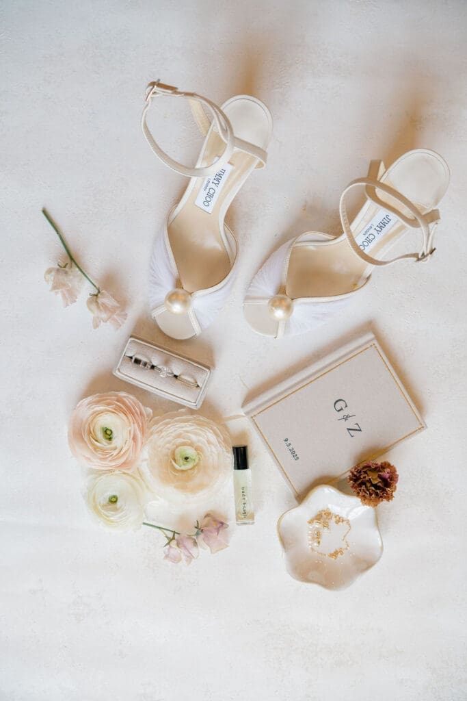 Bridal wedding details including Jimmy Choo shoes, rings, and florals at Renault Winery wedding in New Jersey